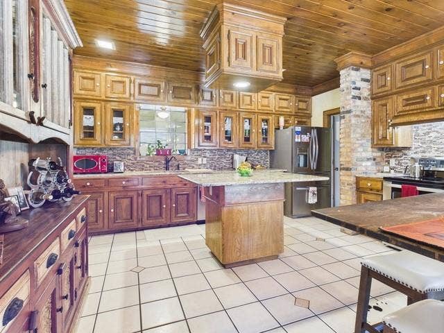 2382 Crystal Drive, Athens, TX 75752 Kitchen with wooden ceiling, appliances with stainless steel finishes, tasteful backsplash, a kitchen island, and ornamental molding