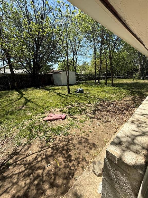 6036 Harrison Way, Watauga, TX 76148 Fenced backyard with a shed