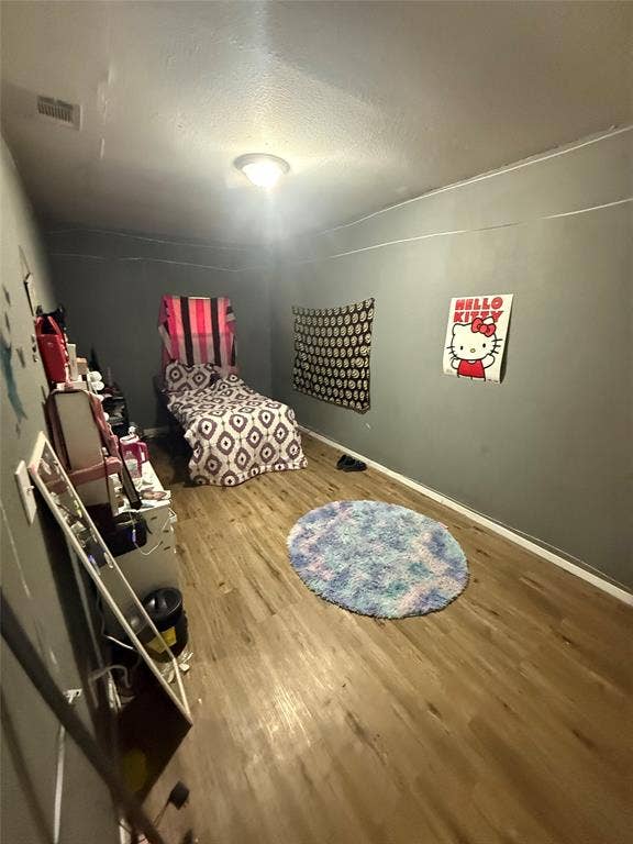 6036 Harrison Way, Watauga, TX 76148 Bedroom with wood finished floors and baseboards
