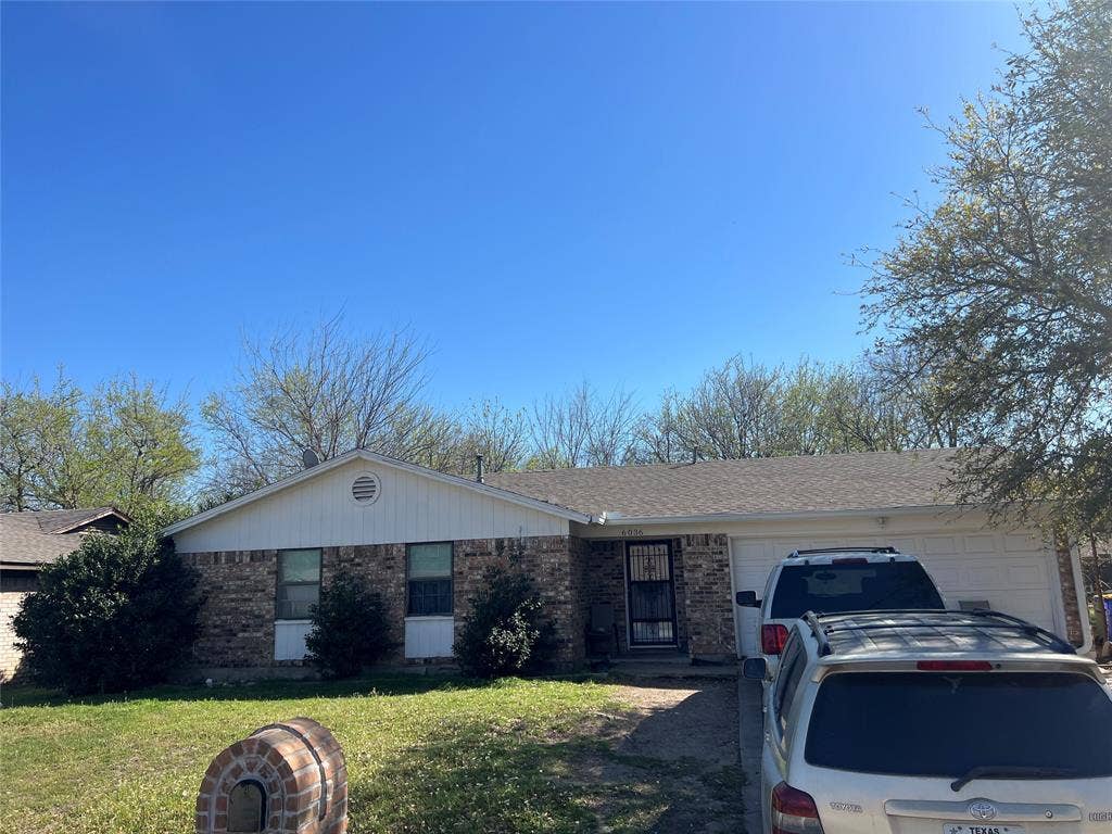 6036 Harrison Way, Watauga, TX 76148 Single story home with brick siding, a garage, a front yard, and roof with shingles