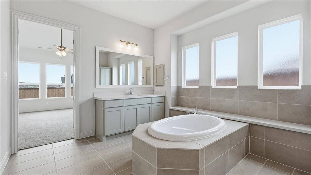 331 Fire Blade Drive, Aledo, TX 76008 Soaking tub with tiled surround, flanked by three rectangular windows