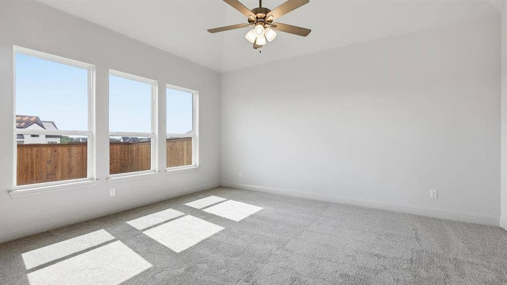 331 Fire Blade Drive, Aledo, TX 76008 Bright interior room featuring a vaulted ceiling, three large windows, a ceiling fan with integrated lighting, and neutral carpeting