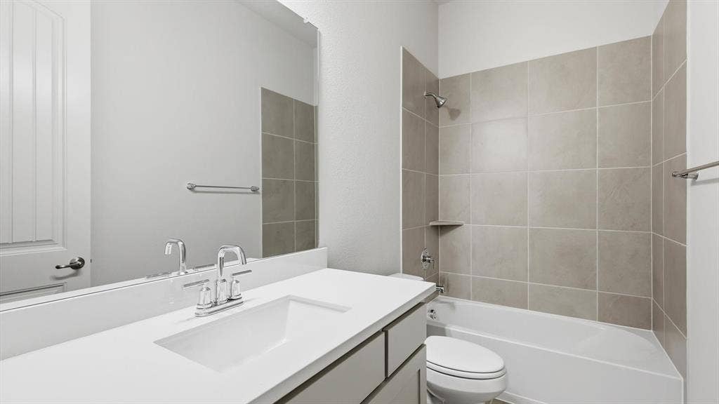 331 Fire Blade Drive, Aledo, TX 76008 Bathroom featuring a white integrated sink with chrome faucet, light grey vanity cabinetry, and a full-width mirror