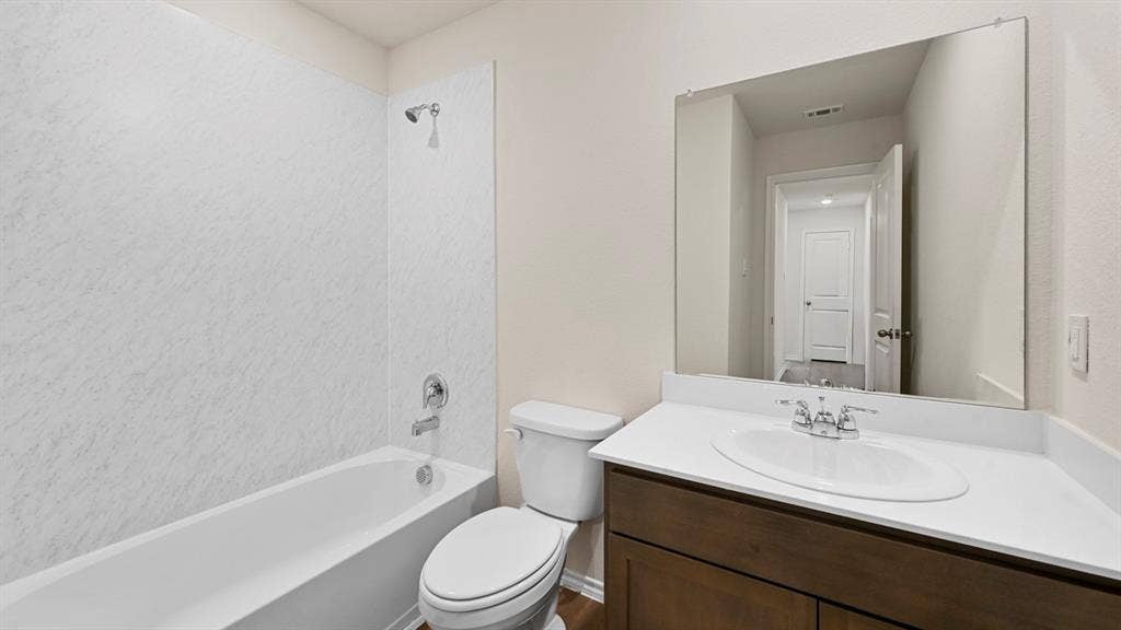 1635 Blaire Drive, Tyler, TX 75702 Bathroom featuring vanity and bathtub / shower combination