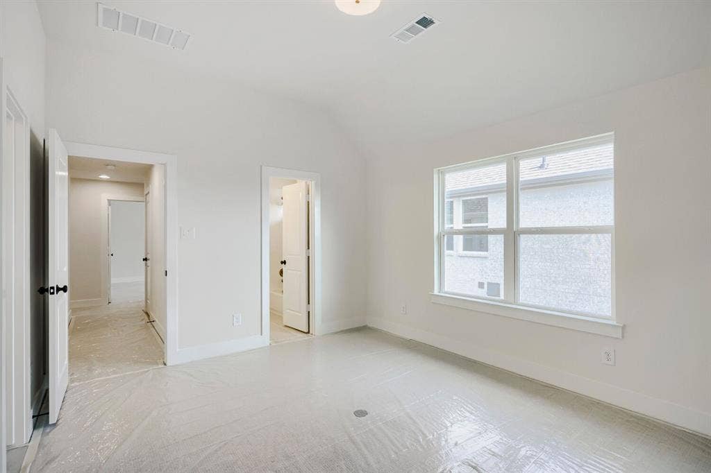 940 Heatherbrook Drive, Prosper, TX 75078 Bright interior space with a vaulted ceiling, white walls, and a large window providing ambient light