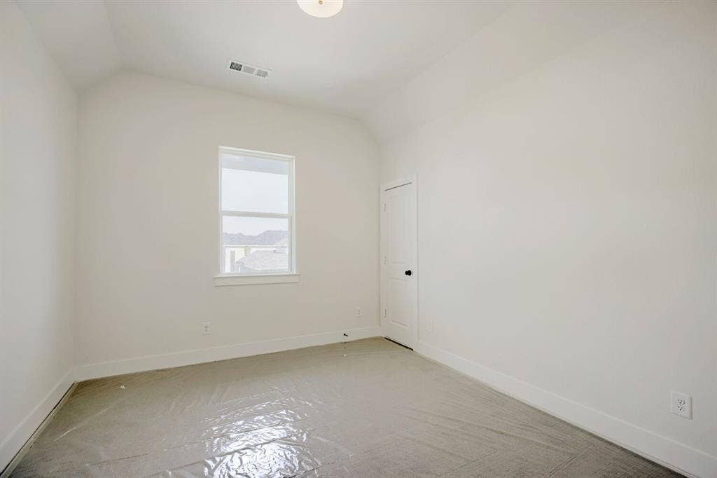 940 Heatherbrook Drive, Prosper, TX 75078 Room featuring a vaulted ceiling and a single window with white trim