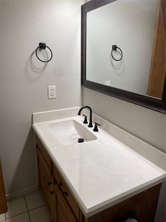 3441 Pewitt Drive, #43, Waco, TX 76706 Bathroom with vanity, light tile patterned floors, and a textured wall
