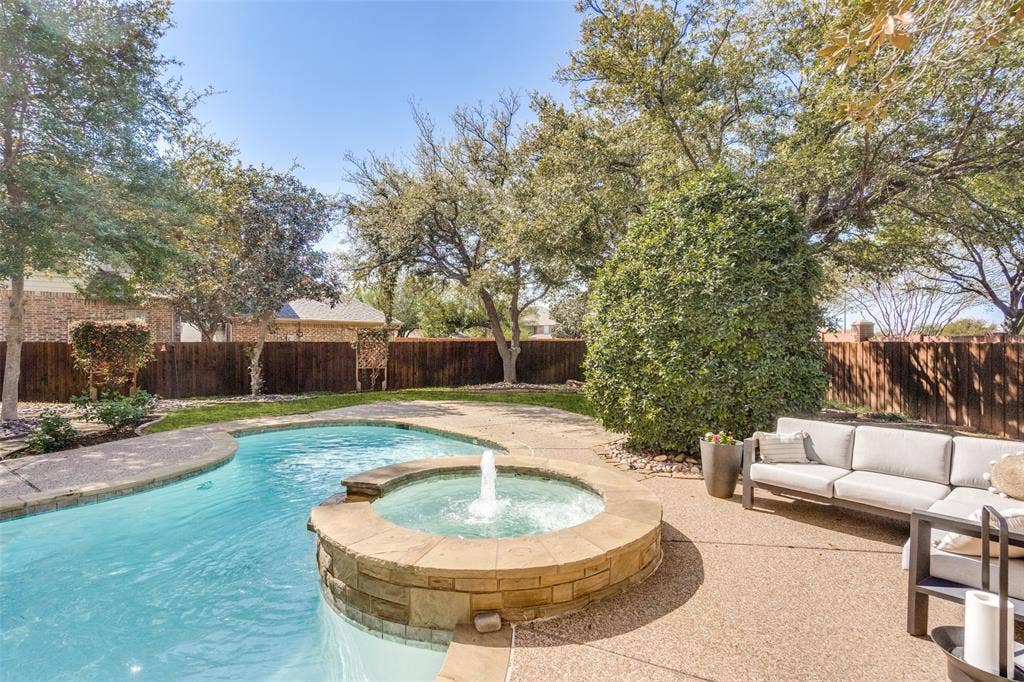 Large pool with spa and plenty of seating.