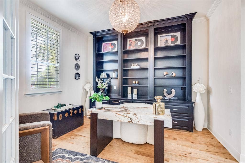 Large office with built-ins and plantation shutters.