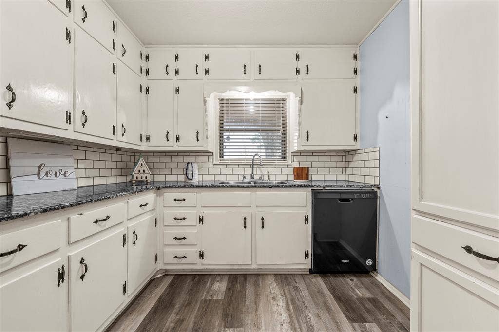 901 N Main Street, West, TX 76691 Kitchen with black dishwasher, dark stone counters, white cabinetry, and dark wood finished floors