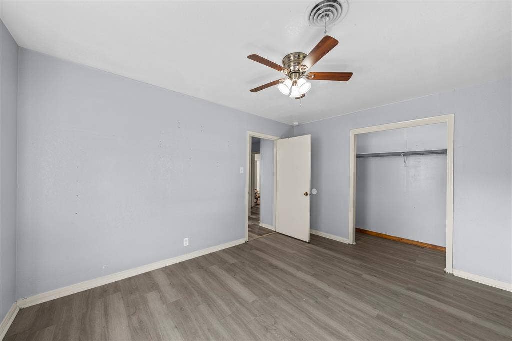 901 N Main Street, West, TX 76691 Unfurnished bedroom featuring wood finished floors, ceiling fan, and a closet