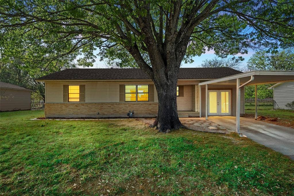 901 N Main Street, West, TX 76691 Single story home with brick siding, french doors, a carport, and driveway