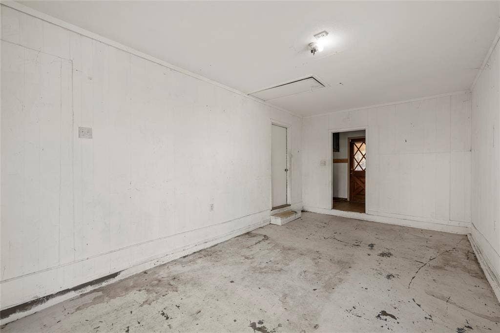 901 N Main Street, West, TX 76691 Spare room with unfinished concrete flooring and wooden walls