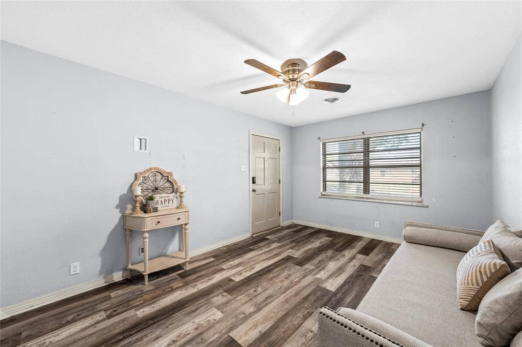 901 N Main Street, West, TX 76691 Living area with dark wood finished floors and a ceiling fan
