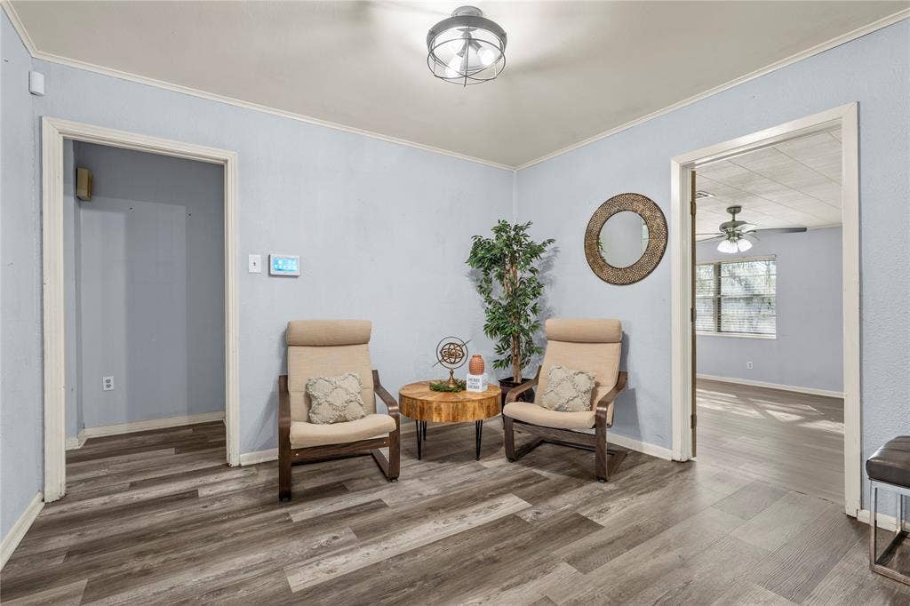 901 N Main Street, West, TX 76691 Living area with wood finished floors, a ceiling fan, and ornamental molding