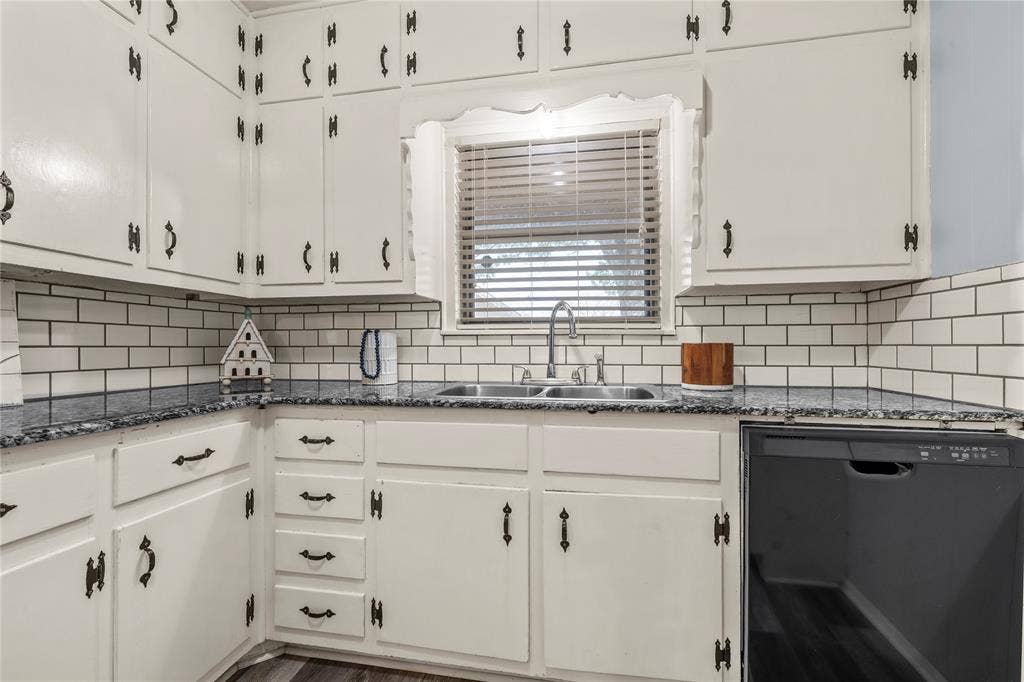 901 N Main Street, West, TX 76691 Kitchen with dishwasher, white cabinets, dark stone countertops, and decorative backsplash