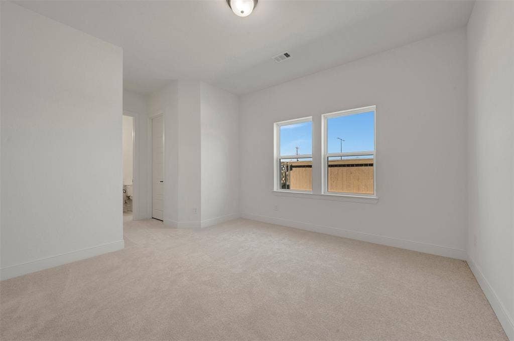 1709 Drover Street, Northlake, TX 76247 Spacious room featuring neutral carpeting, white baseboards, and two large windows