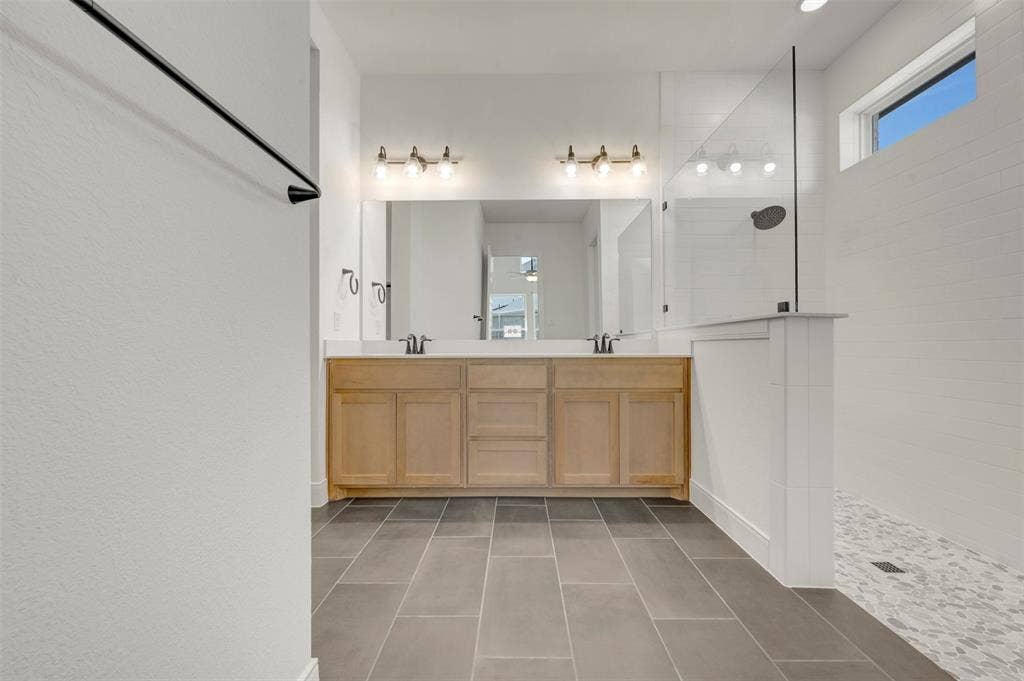 1709 Drover Street, Northlake, TX 76247 Dual vanity with light wood-finish cabinetry and white countertops