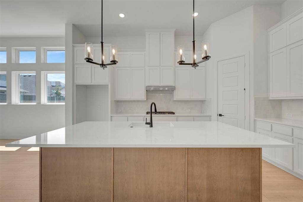 1709 Drover Street, Northlake, TX 76247 Kitchen featuring a large central island with a light wood-finish base and white countertop