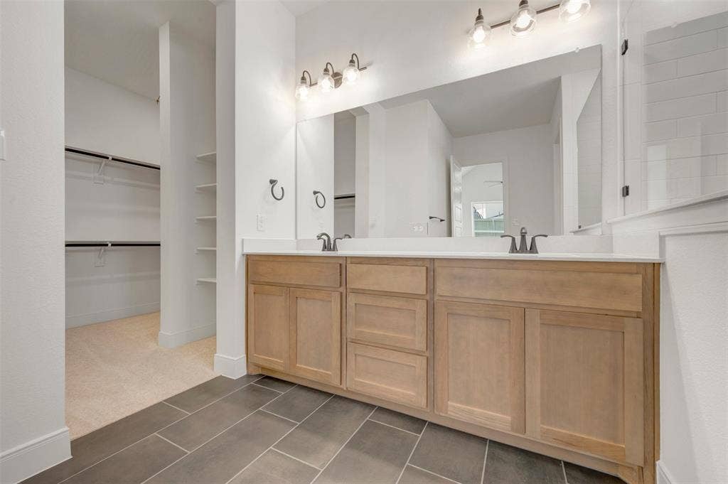 1709 Drover Street, Northlake, TX 76247 Dual vanity with light wood-finish cabinetry and white countertops