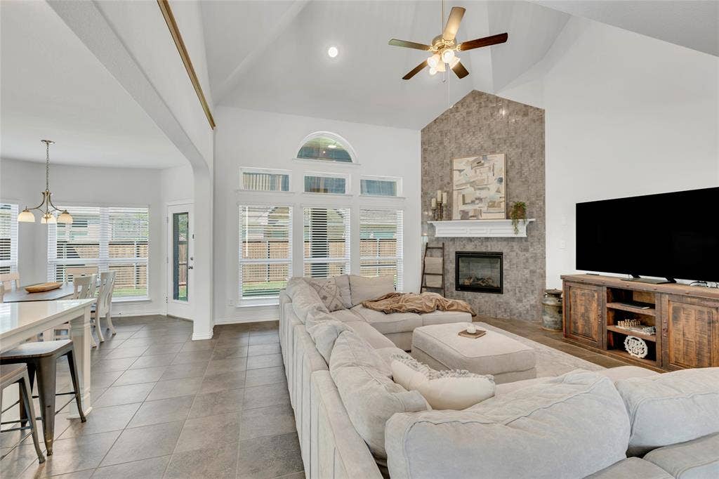 566 Long Meadow Drive, Haslet, TX 76052 Open concept with vaulted ceilings. The kitchen overlooks the living and a beautiful tile surrounded fireplace.