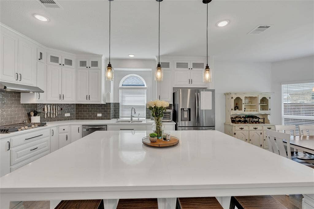 566 Long Meadow Drive, Haslet, TX 76052 The meeting place! This island has room for 4 barstools and is the center-piece of the kitchen. Many meals can grace this space with room for everyone!