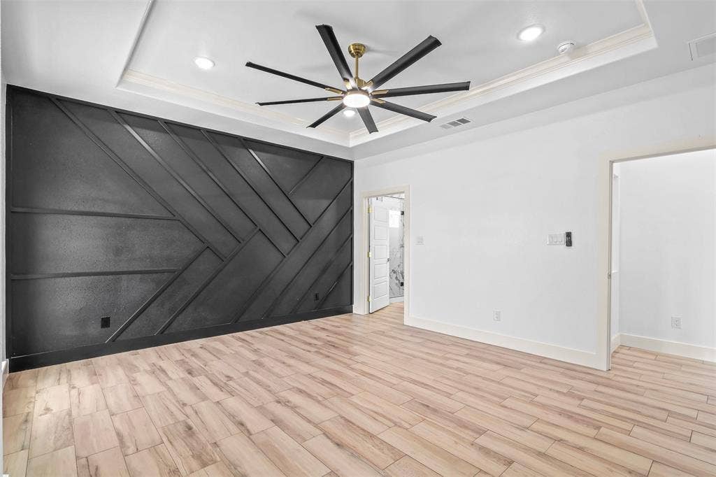 271 Victory Drive, Mabank, TX 75147 Spare room with light wood-style floors, a decorative wall, ceiling fan, a tray ceiling, and crown molding