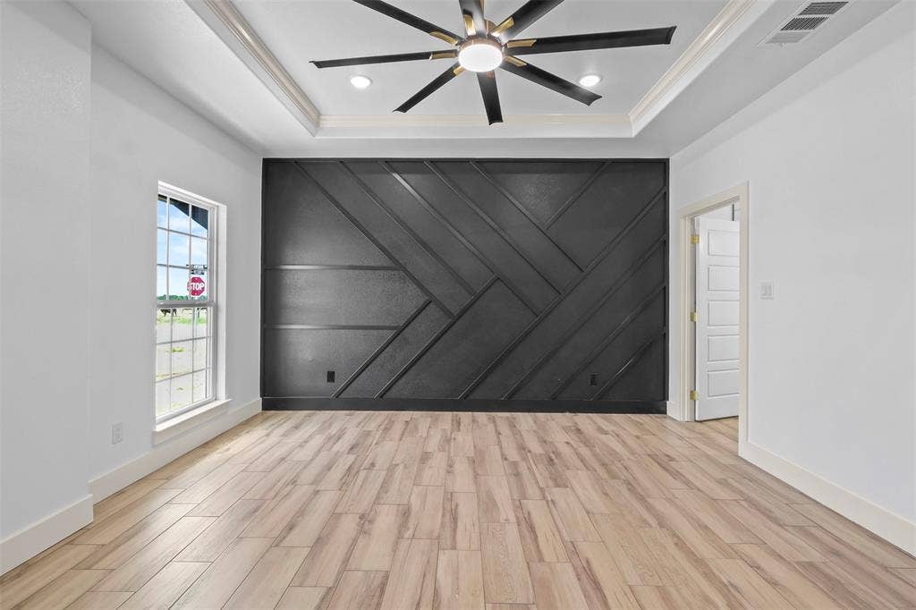 271 Victory Drive, Mabank, TX 75147 Unfurnished room with wood tiled floors, a decorative wall, a ceiling fan, a raised ceiling, and recessed lighting