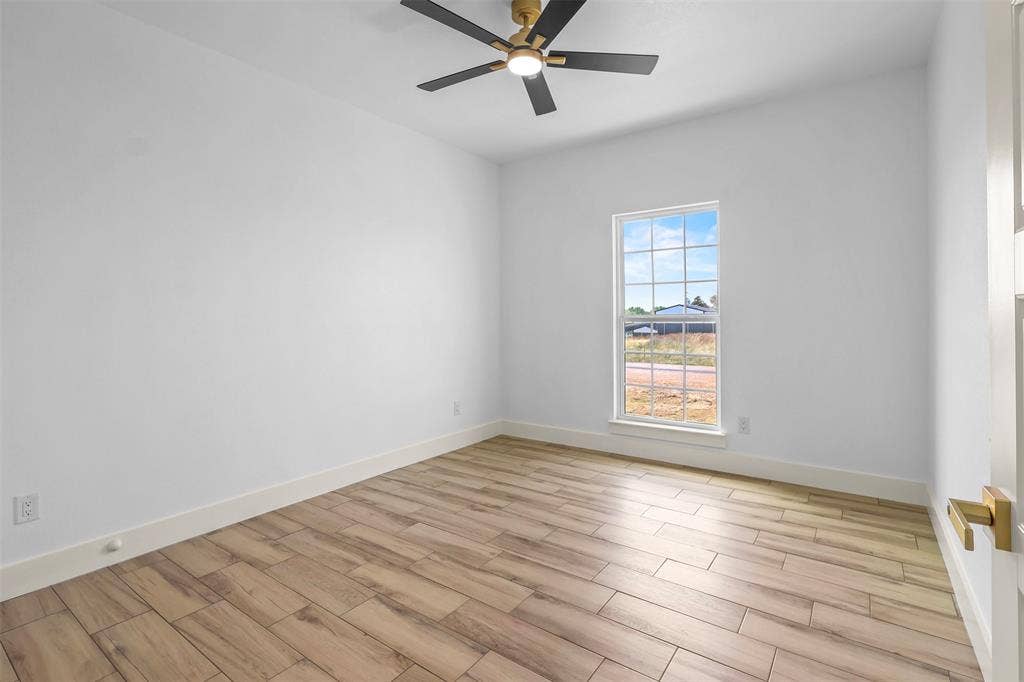 271 Victory Drive, Mabank, TX 75147 Empty room featuring wood finish floors and a ceiling fan