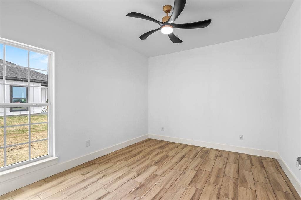 271 Victory Drive, Mabank, TX 75147 Empty room featuring wood finish floors and ceiling fan