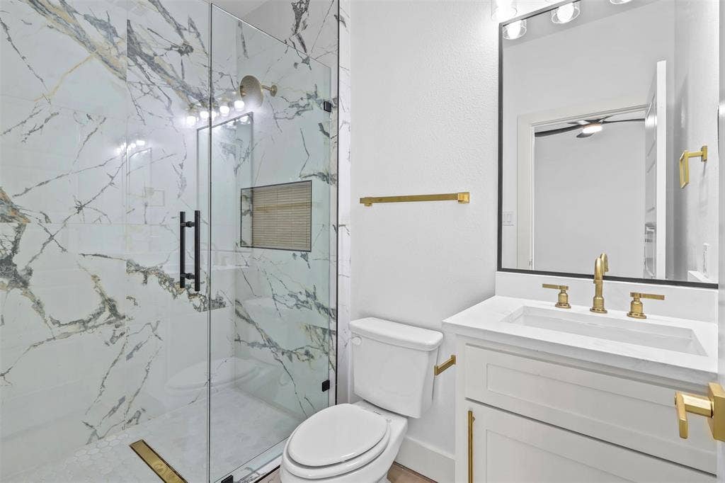 271 Victory Drive, Mabank, TX 75147 Bathroom featuring vanity and a marble finish shower