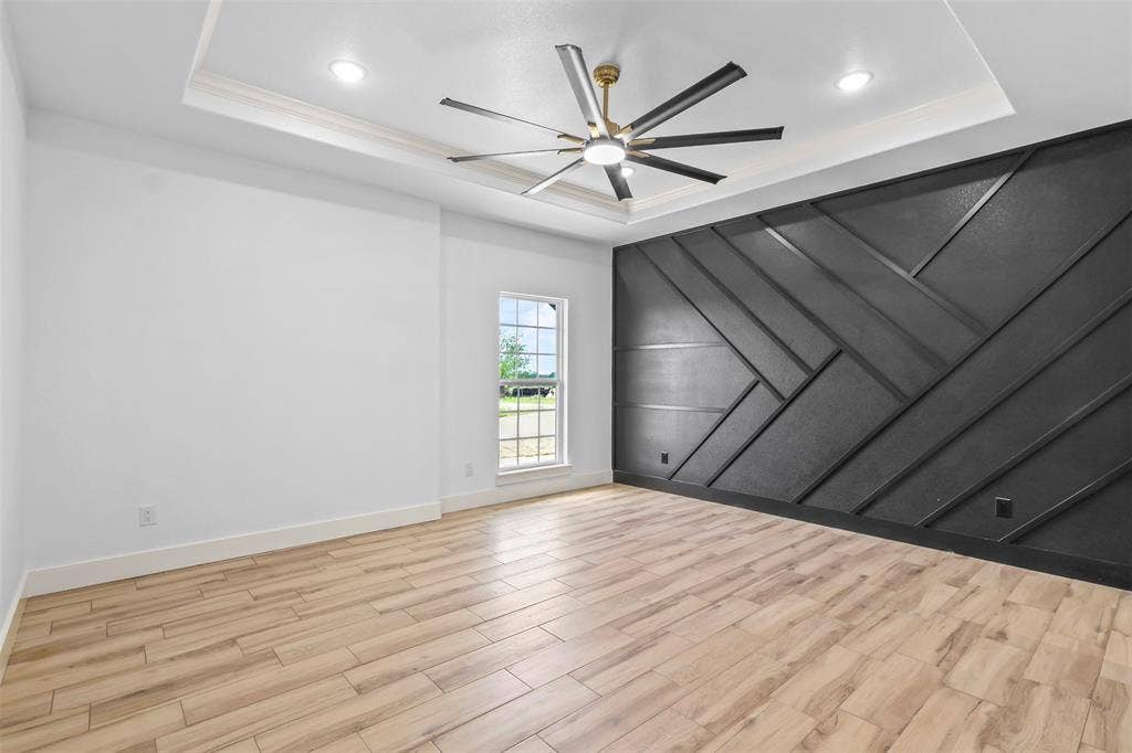 271 Victory Drive, Mabank, TX 75147 Unfurnished room featuring a decorative wall, light wood-style flooring, a ceiling fan, and recessed lighting