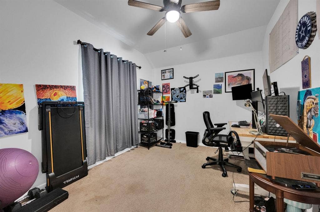2609 Centurion Road, Glenn Heights, TX 75154 Home office featuring light carpet, vaulted ceiling, and a ceiling fan