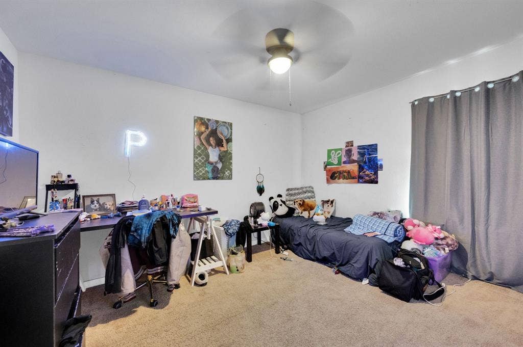 2609 Centurion Road, Glenn Heights, TX 75154 Carpeted bedroom featuring ceiling fan and a desk