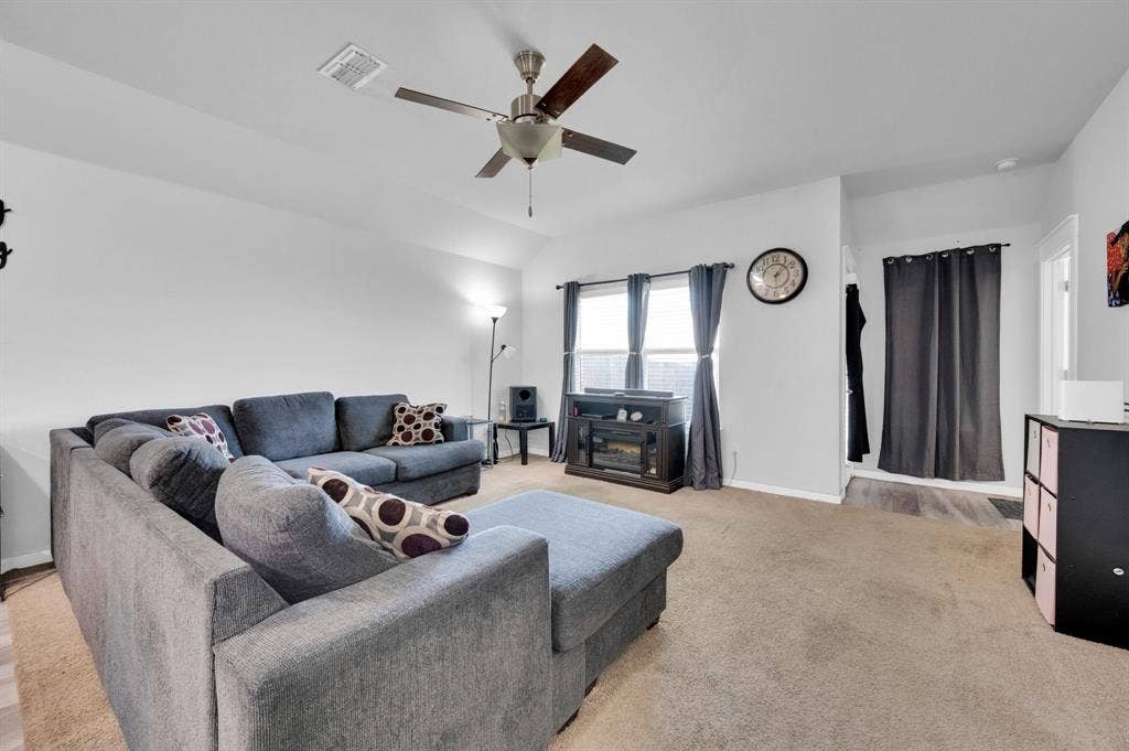 2609 Centurion Road, Glenn Heights, TX 75154 Living room featuring a ceiling fan, light colored carpet, and vaulted ceiling
