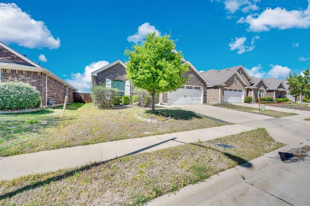 2609 Centurion Road, Glenn Heights, TX 75154 View of front of home with concrete driveway, a residential view, a garage, and brick siding