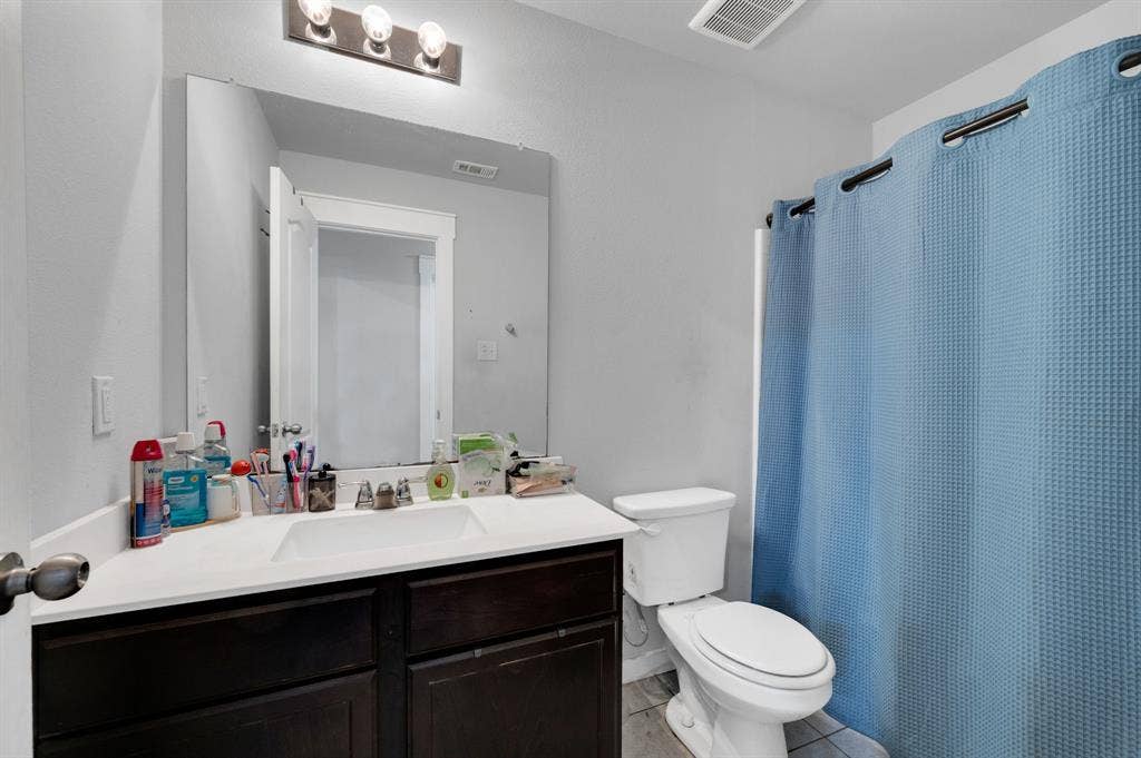 2609 Centurion Road, Glenn Heights, TX 75154 Full bathroom featuring vanity, a shower with curtain, and light tile patterned floors