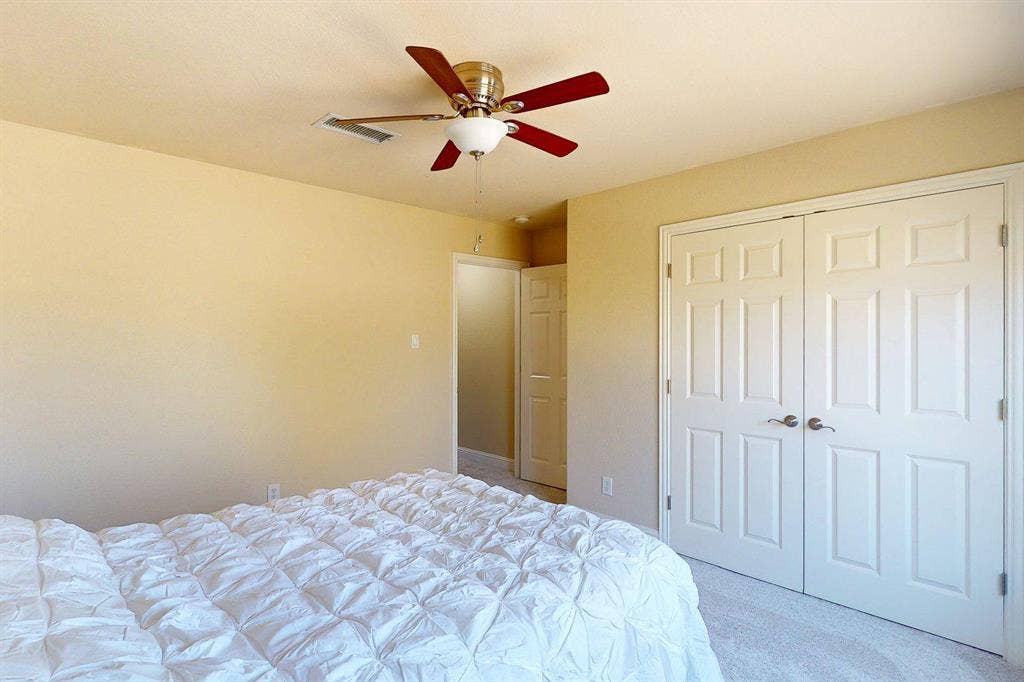 349 Creekside Trail, Argyle, TX 76226 Bedroom featuring a closet, ceiling fan, and light colored carpet