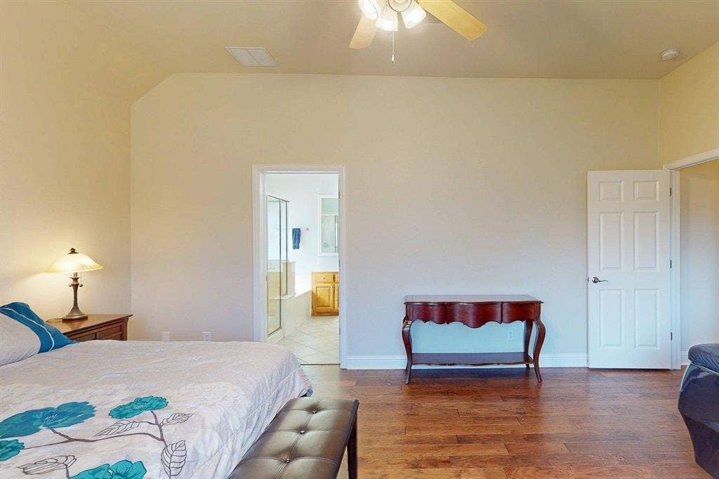 349 Creekside Trail, Argyle, TX 76226 Bedroom featuring wood finished floors, a ceiling fan, and ensuite bath