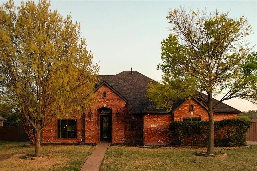 349 Creekside Trail, Argyle, TX 76226 Brick exterior with dark roofing and a covered arched entry