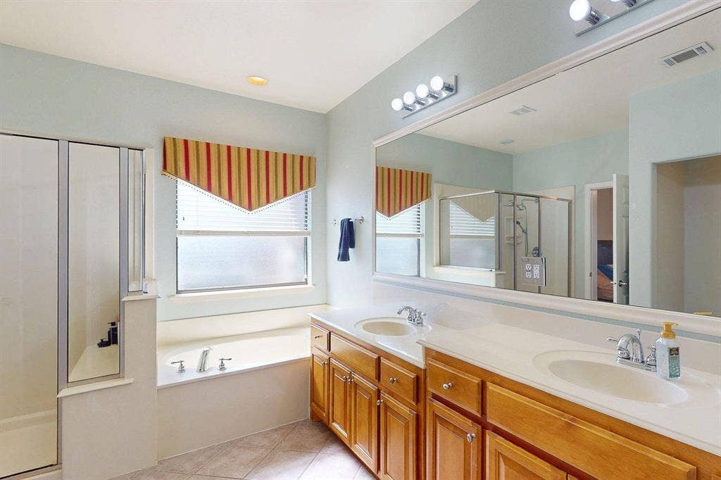 349 Creekside Trail, Argyle, TX 76226 Full bath with a stall shower, a garden tub, double vanity, and light tile patterned floors