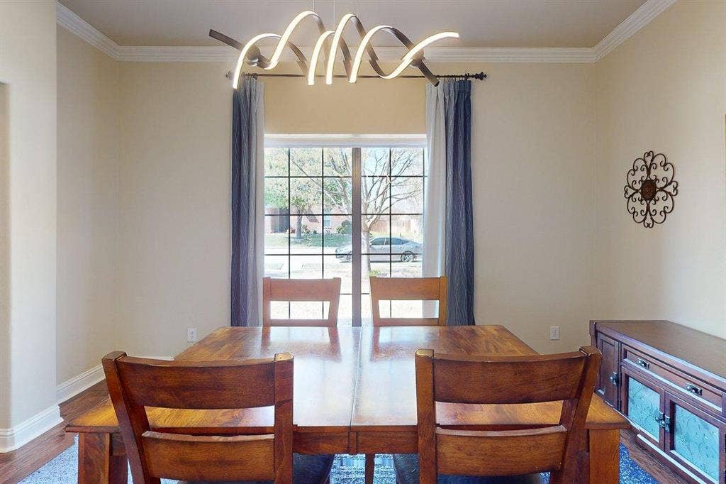 349 Creekside Trail, Argyle, TX 76226 Dining room featuring ornamental molding, suspended lighting, and dark wood-type flooring