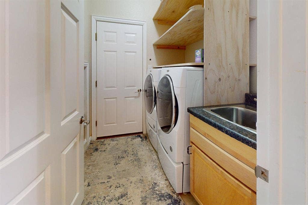 349 Creekside Trail, Argyle, TX 76226 Laundry room with washing machine and clothes dryer and a sink