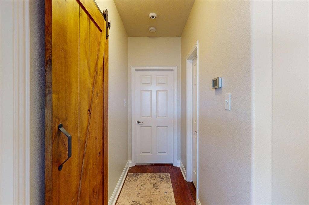 349 Creekside Trail, Argyle, TX 76226 Corridor featuring a barn door and dark wood-style floors