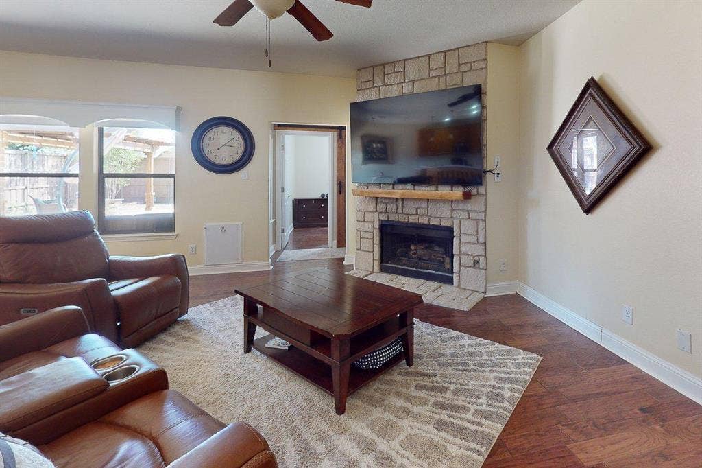 349 Creekside Trail, Argyle, TX 76226 Living area featuring dark wood-style floors, a fireplace, and ceiling fan