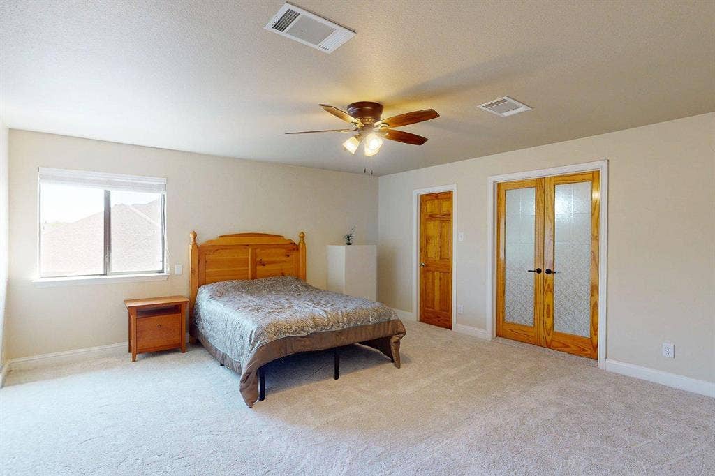 349 Creekside Trail, Argyle, TX 76226 Bedroom featuring french doors, light colored carpet, and a ceiling fan