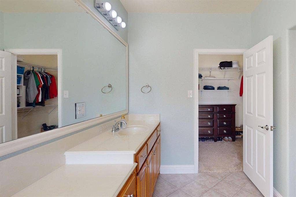 349 Creekside Trail, Argyle, TX 76226 Full bathroom with a spacious closet, vanity, light carpet, and light tile patterned floors