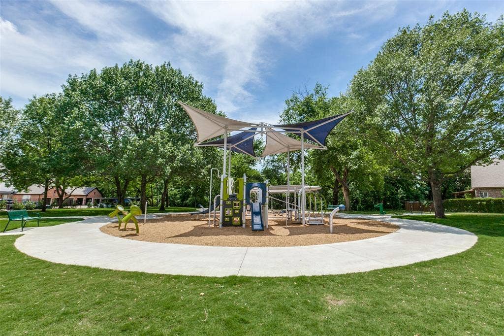 2632 Barrington Drive, Plano, TX 75093 Community playground featuring a multi-level play structure with slides and climbing elements, shaded by a fabric canopy