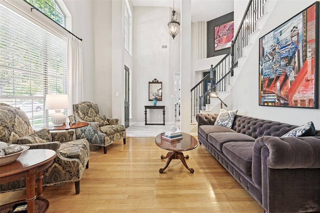 2632 Barrington Drive, Plano, TX 75093 Two-story foyer with hardwood flooring, a prominent staircase featuring black wrought iron spindles, and a large arched window