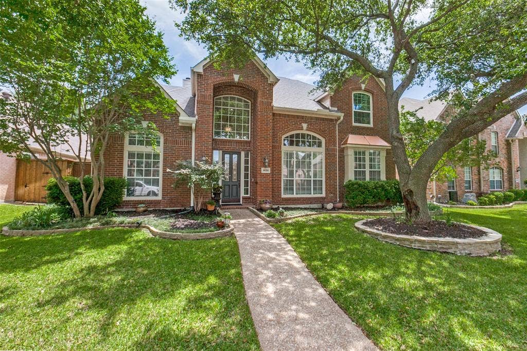 2632 Barrington Drive, Plano, TX 75093 Brick exterior with a prominent arched entry window and decorative transom